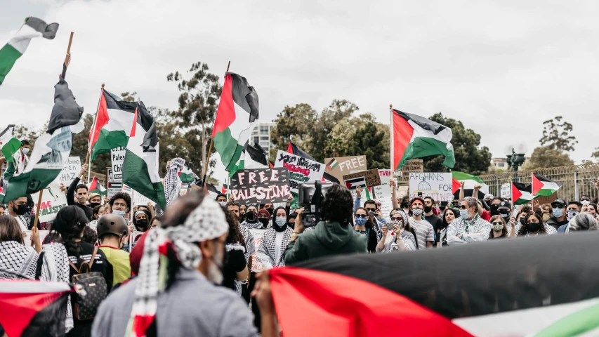 a group of people holding banners and flags