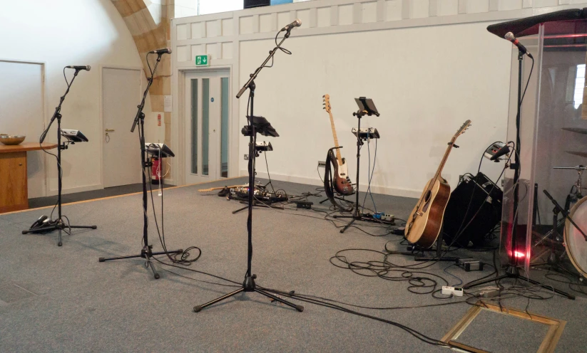 a room with many guitars and musical equipment