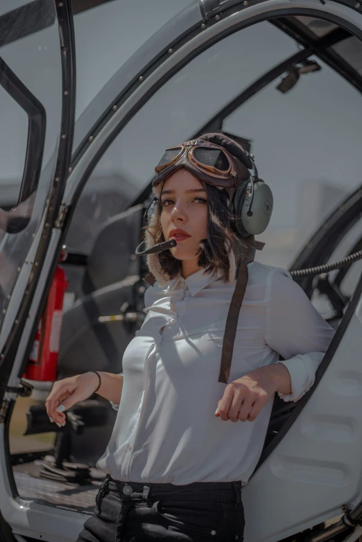 woman in a helicopter looking down at soing while sitting inside