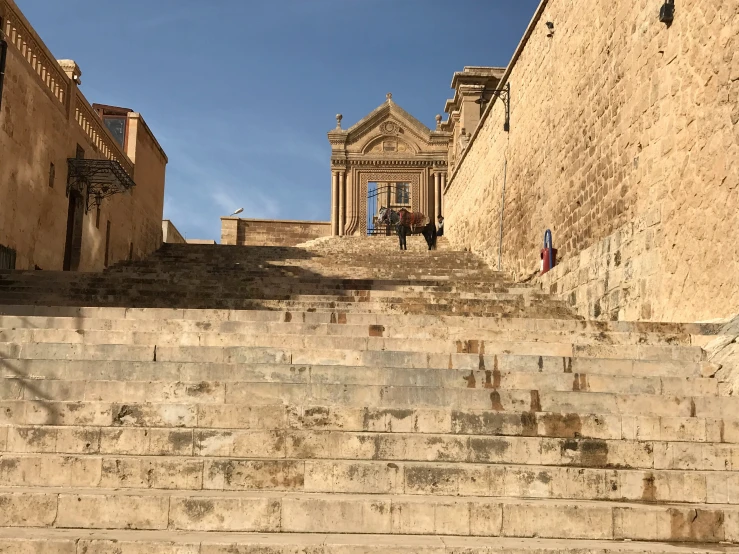 a couple of stone stairs with a building in the background