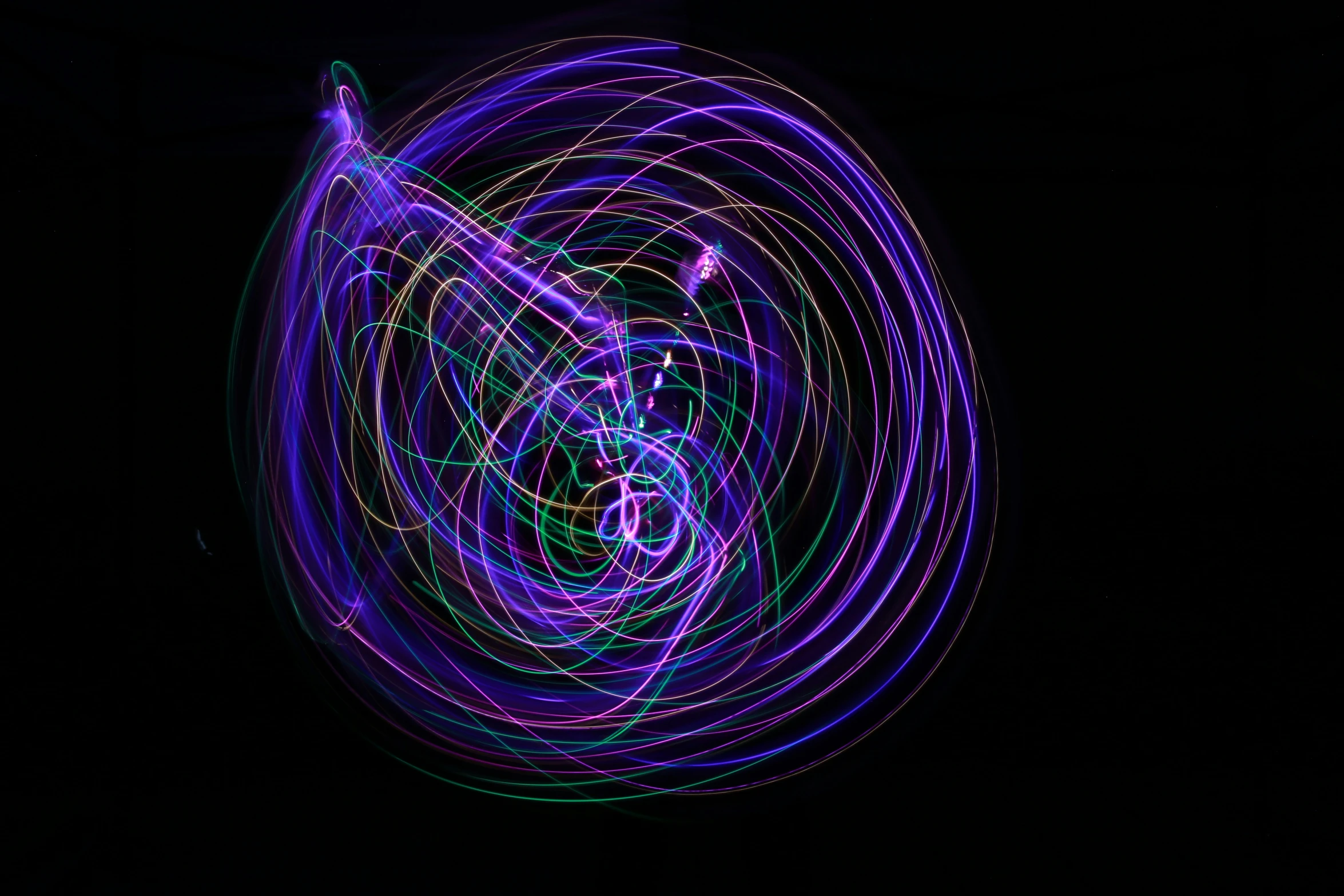 a light painting in the dark with swirls