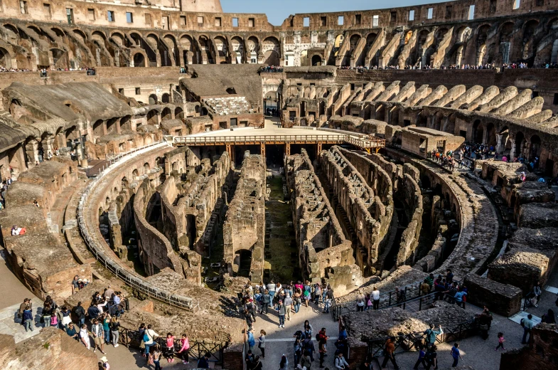 the interior of an ancient building with many people standing inside