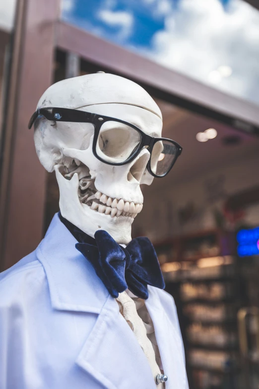 a skeleton with sunglasses, wearing a bow tie