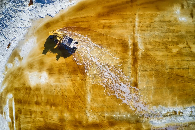 an aerial view of a truck on the dirt road