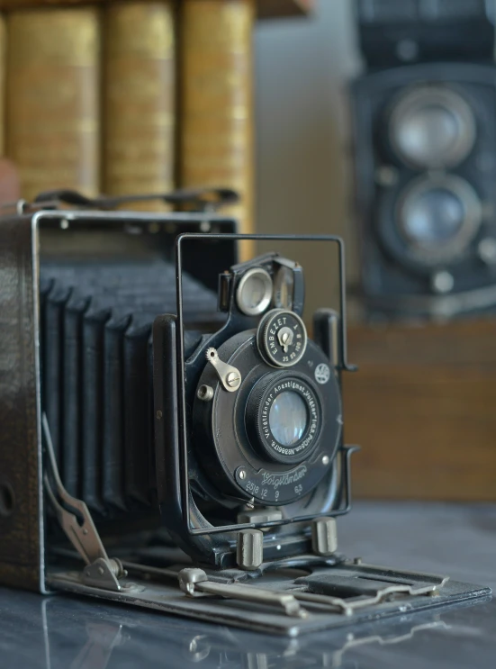 an old vintage camera is sitting on a table