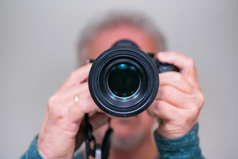 a woman in blue shirt taking a po with a camera