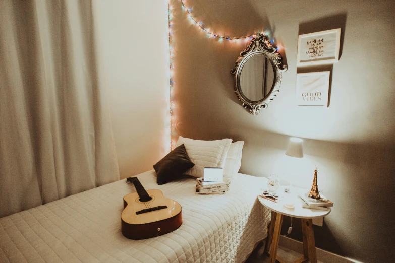 a bed in a bedroom with a guitar on top