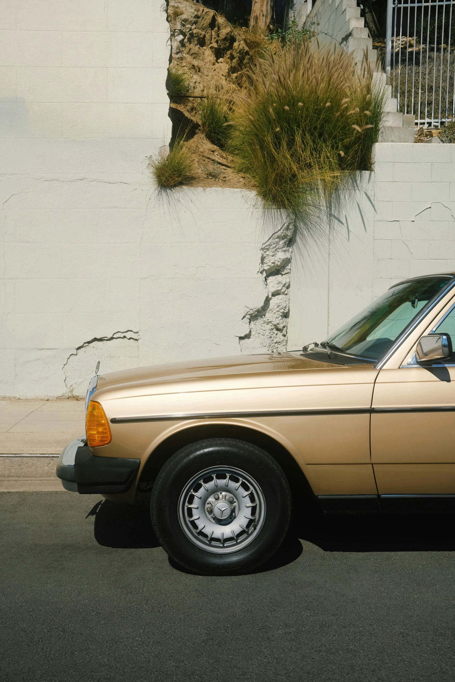 a tan car parked in front of a building