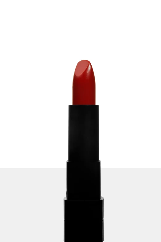 a lipstick is sitting on a black and white surface
