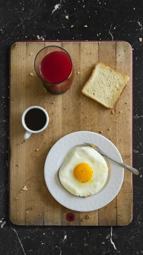 a table that has an egg and bread on it