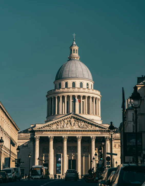 a large white building with a dome and many buildings around it