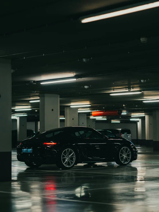 a dimly lit parking garage with cars parked