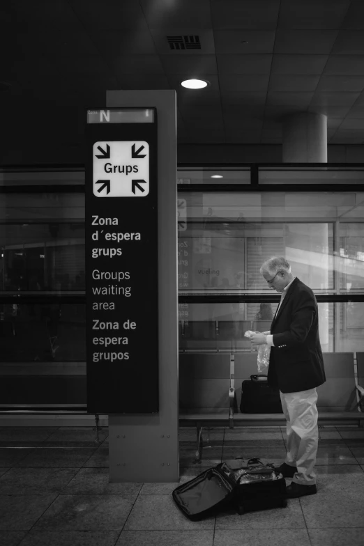 a man standing next to a doorway near luggage