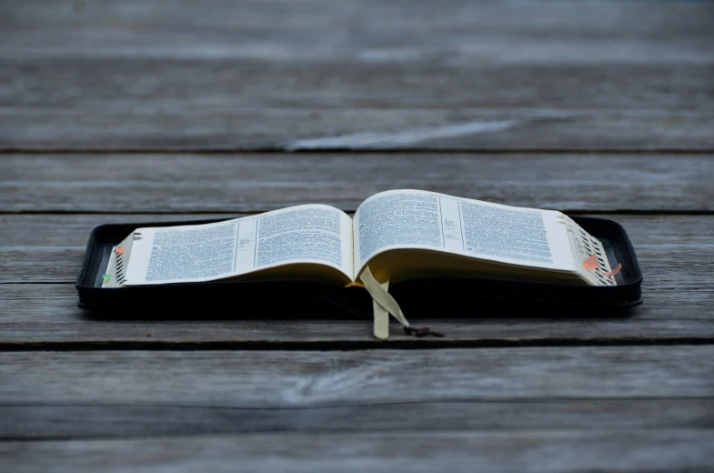 an open book sitting on top of a wooden table