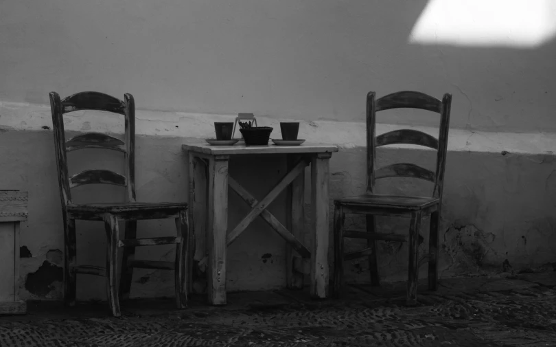 some chairs are set up in front of an old wall