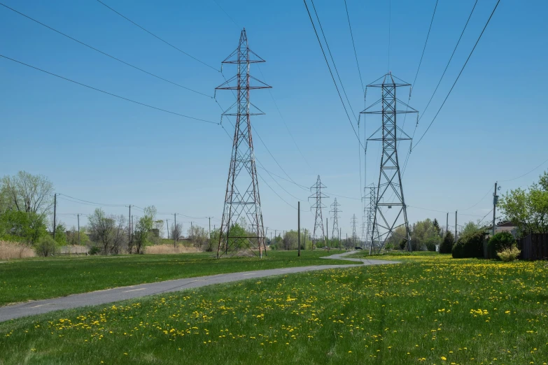 a couple of electric poles next to a path