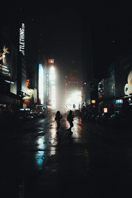 people walking along a busy city street at night