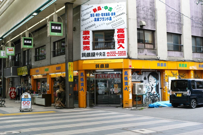 a busy city street lined with stores on both sides