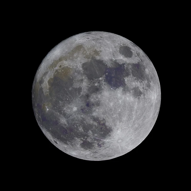 the full moon with black skies in the background