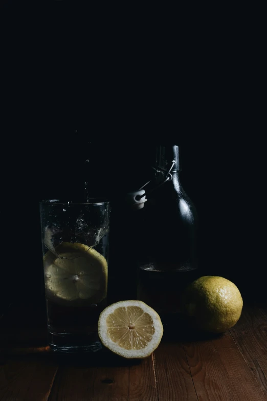 this is a picture of a drink in a pitcher, some lemons and a half