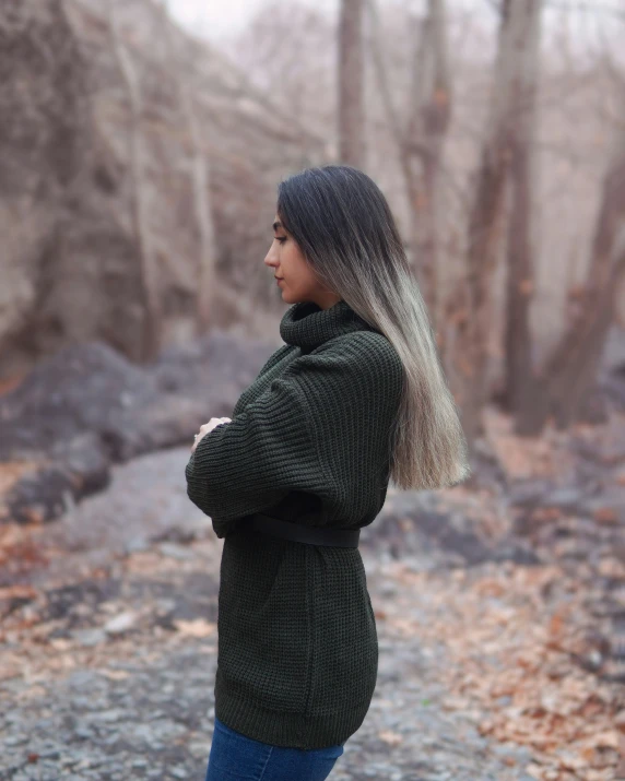 a woman standing alone, looking towards the camera