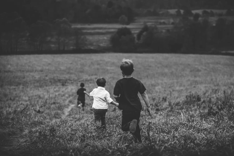black and white image of two s running in a field