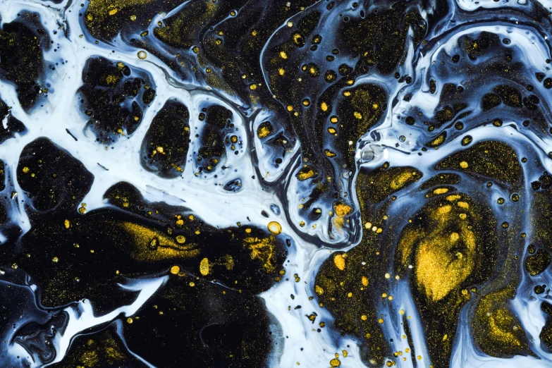 an abstract painting with yellow speckles on black and white