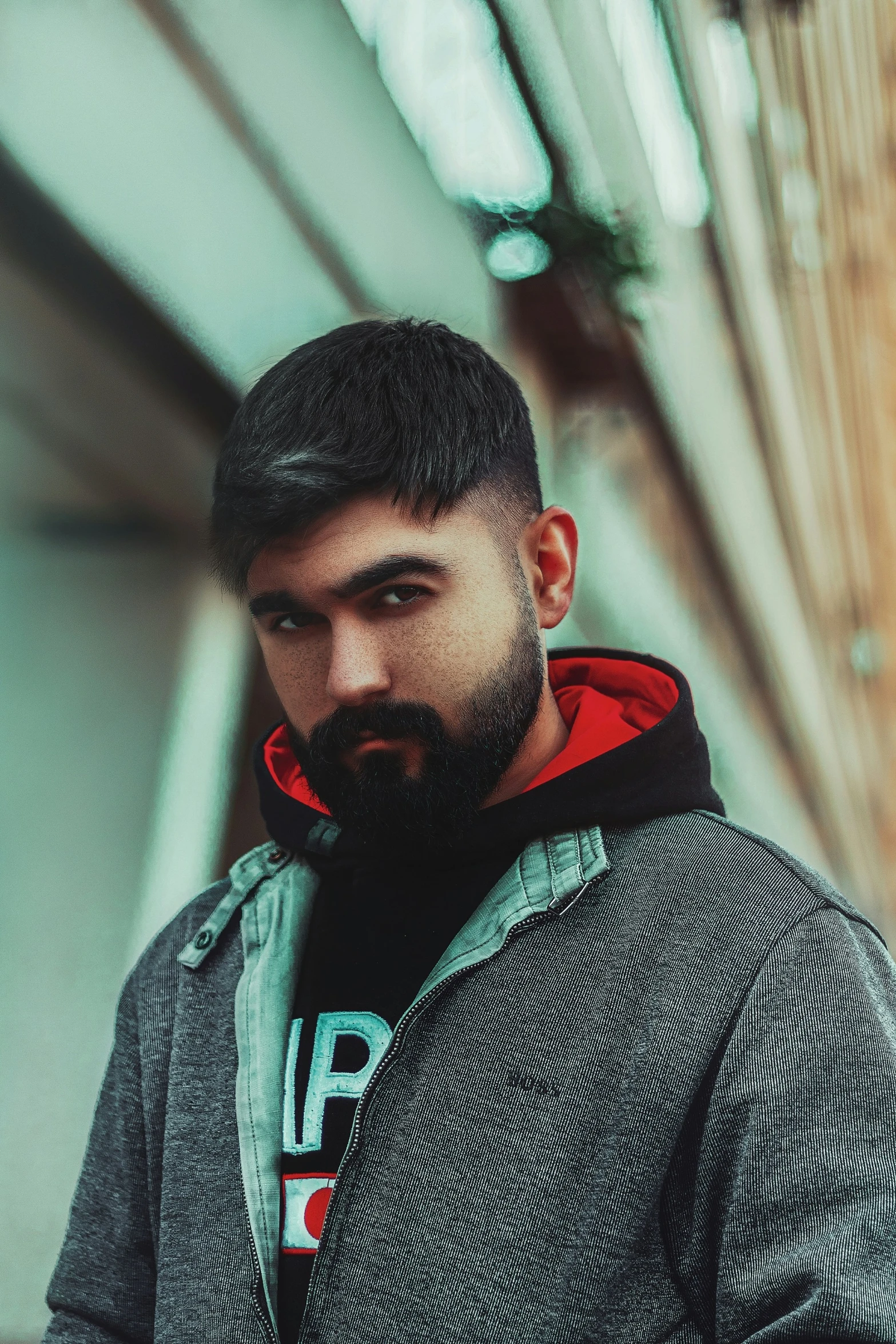 a man standing outside of an office building with a beard