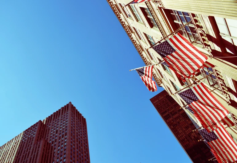 two large buildings next to each other and a tall flag