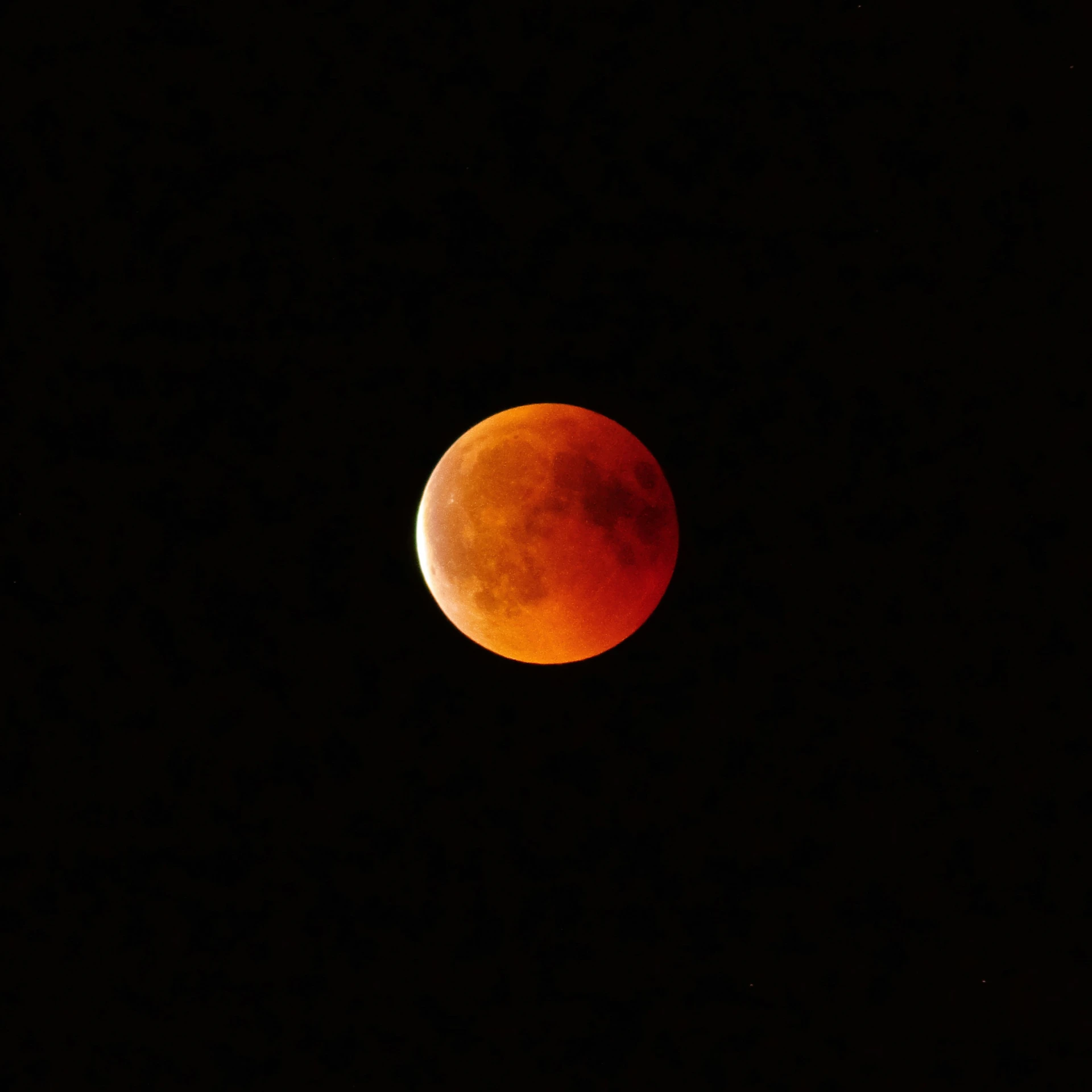 the moon is almost eclipsed over the darkness sky