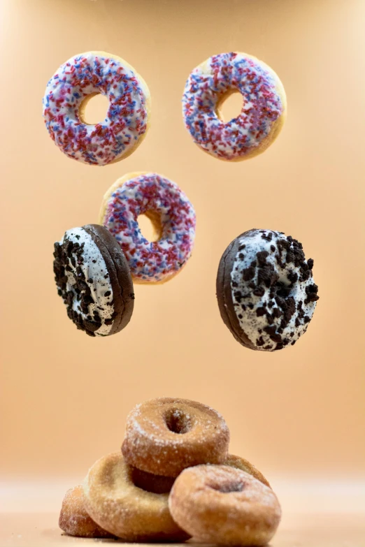 six donuts float together with four flying pastries