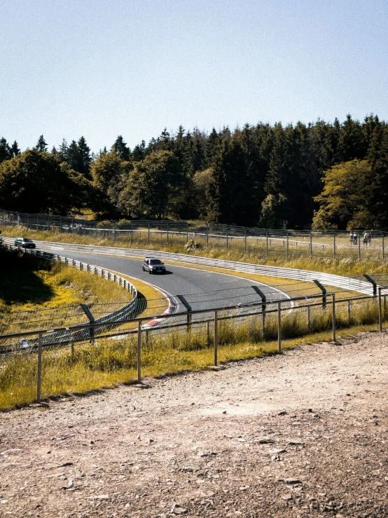 an image of a curved road going around a curve