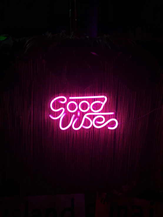 pink neon sign advertising juice in front of dark wall