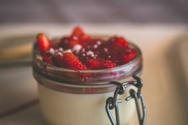 the small jar is filled with sweet food