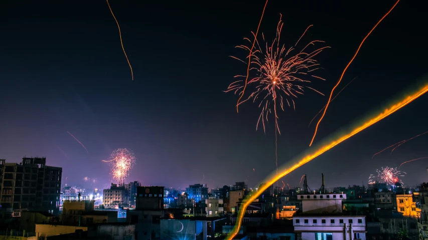 fireworks and lights are glowing up the night sky