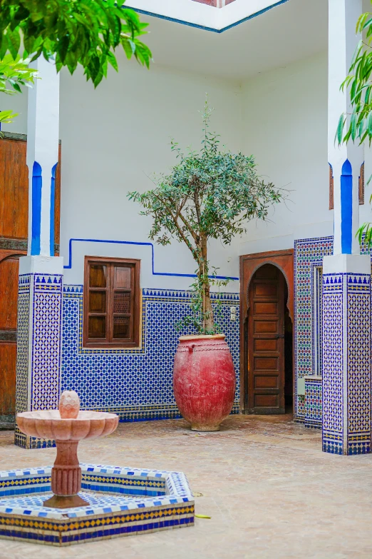 this is a house and courtyard with blue and red tiles