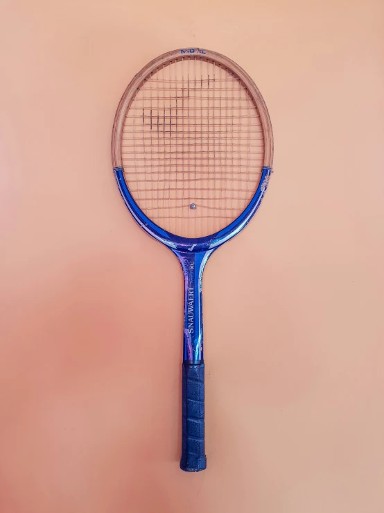 an old tennis racket is leaning against a wall