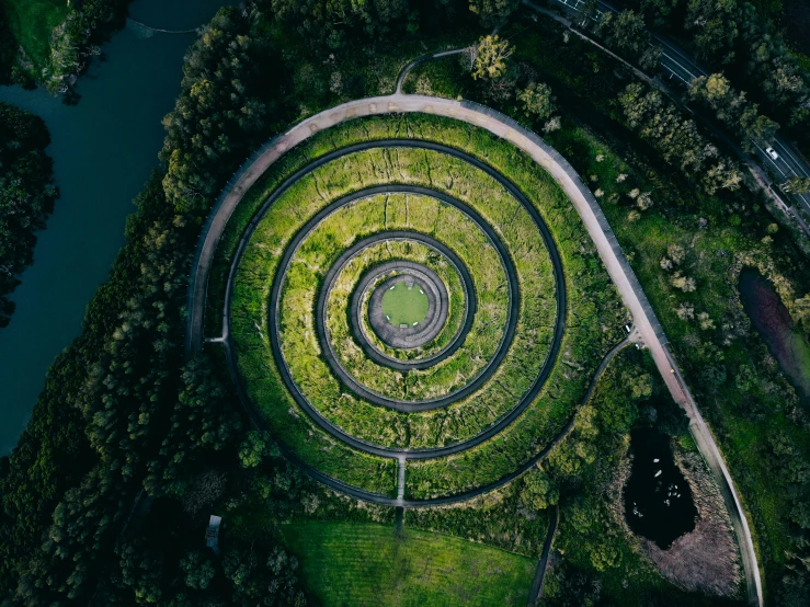 an overhead s of an ancient spiral design in a lush green field