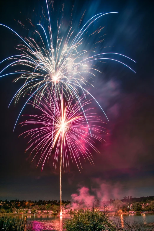 colorful fireworks are lit up in the dark night sky