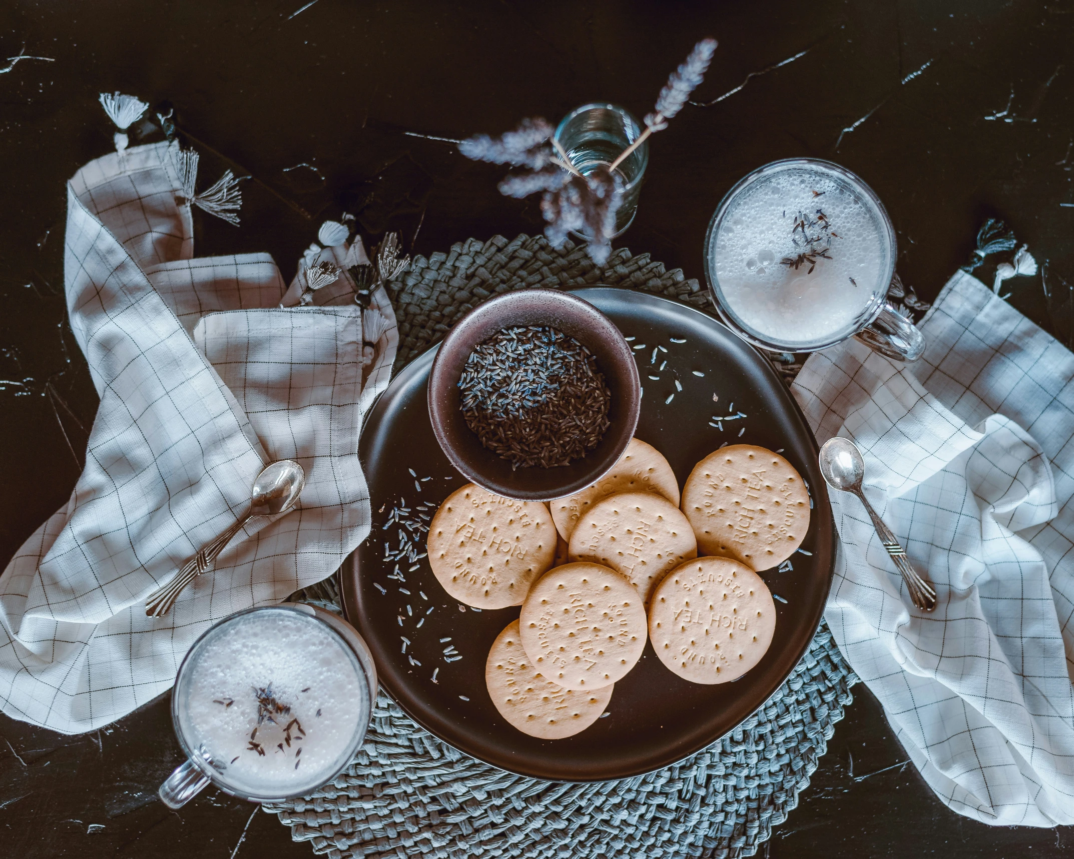 a plate with ers and two cups of milk