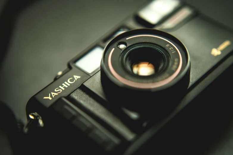 a camera sitting on top of a table next to glasses