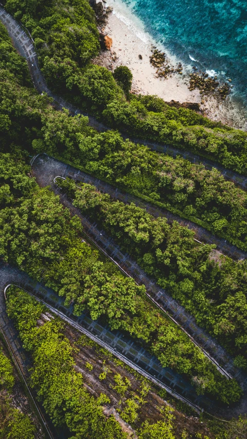 an aerial view of railroad tracks on the coastline