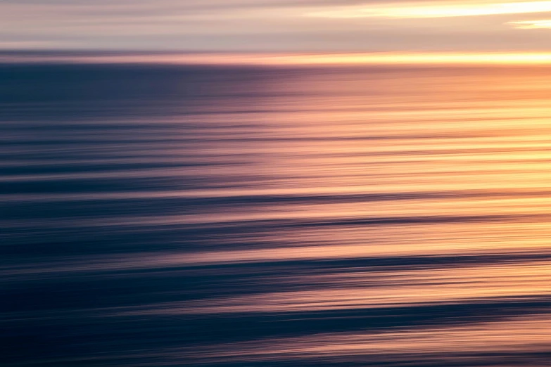 a view of the ocean with sunset reflecting off the water