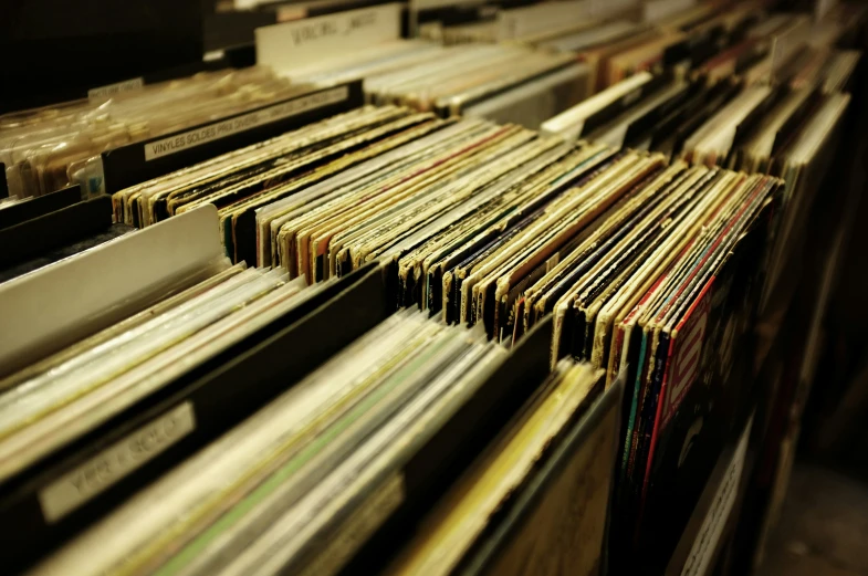 a large stack of various sized records on the shelves