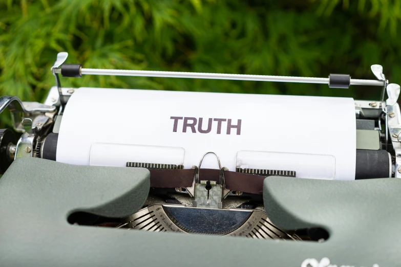 a typewriter is shown with the words truth printed on it