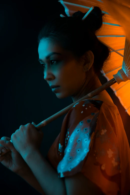 an asian woman with dark hair holds up her parasol