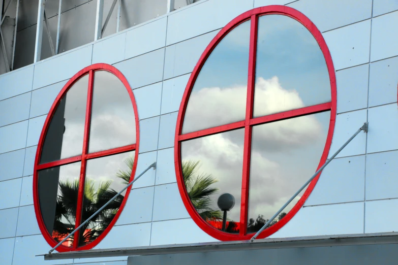 two oval windows that are on the side of a building