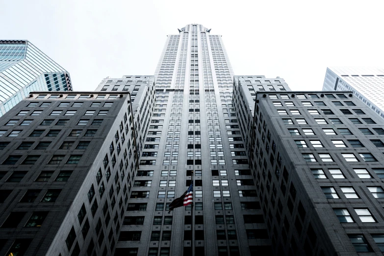 a very tall building with windows and an american flag hanging