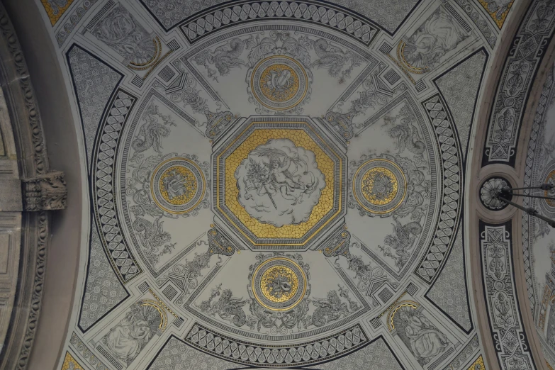 a very artistic gold and black artwork on the ceiling