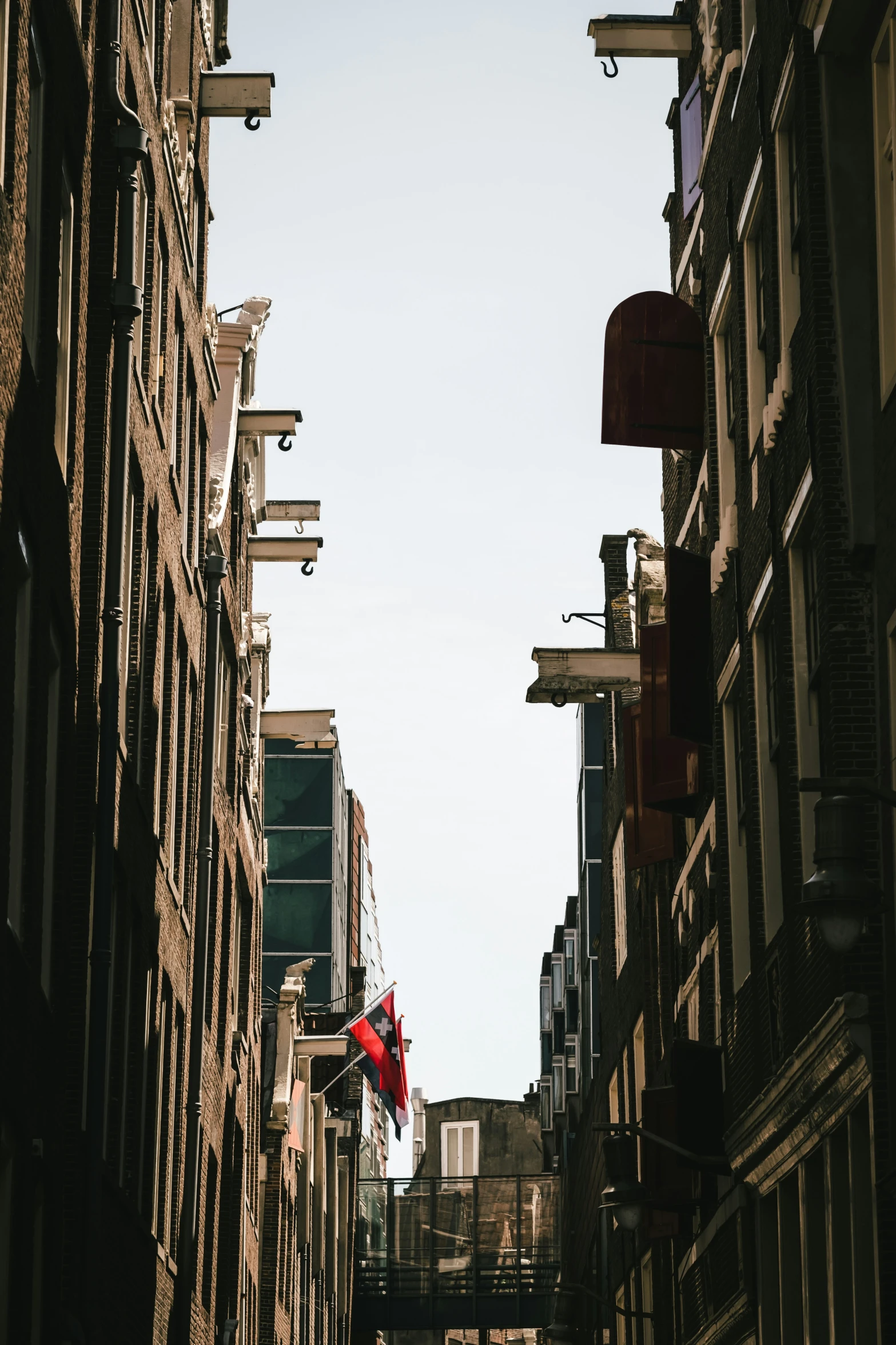 narrow, deserted city street with red traffic signs